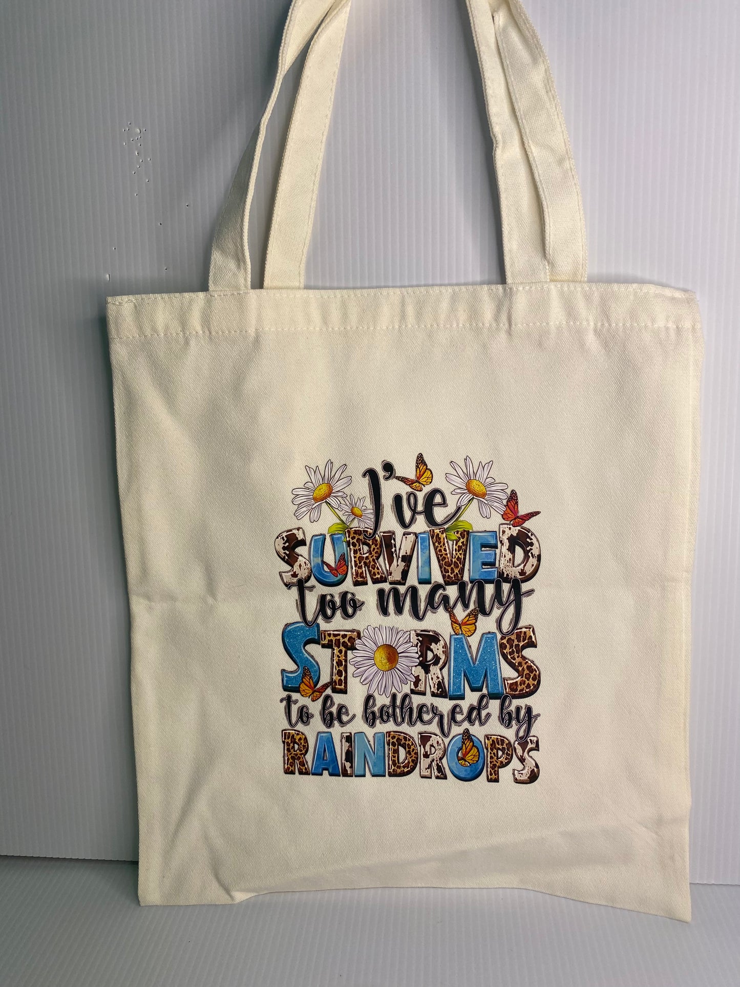 Tote Bag - Sublimated Design, I survived too many Storms. White Daisies