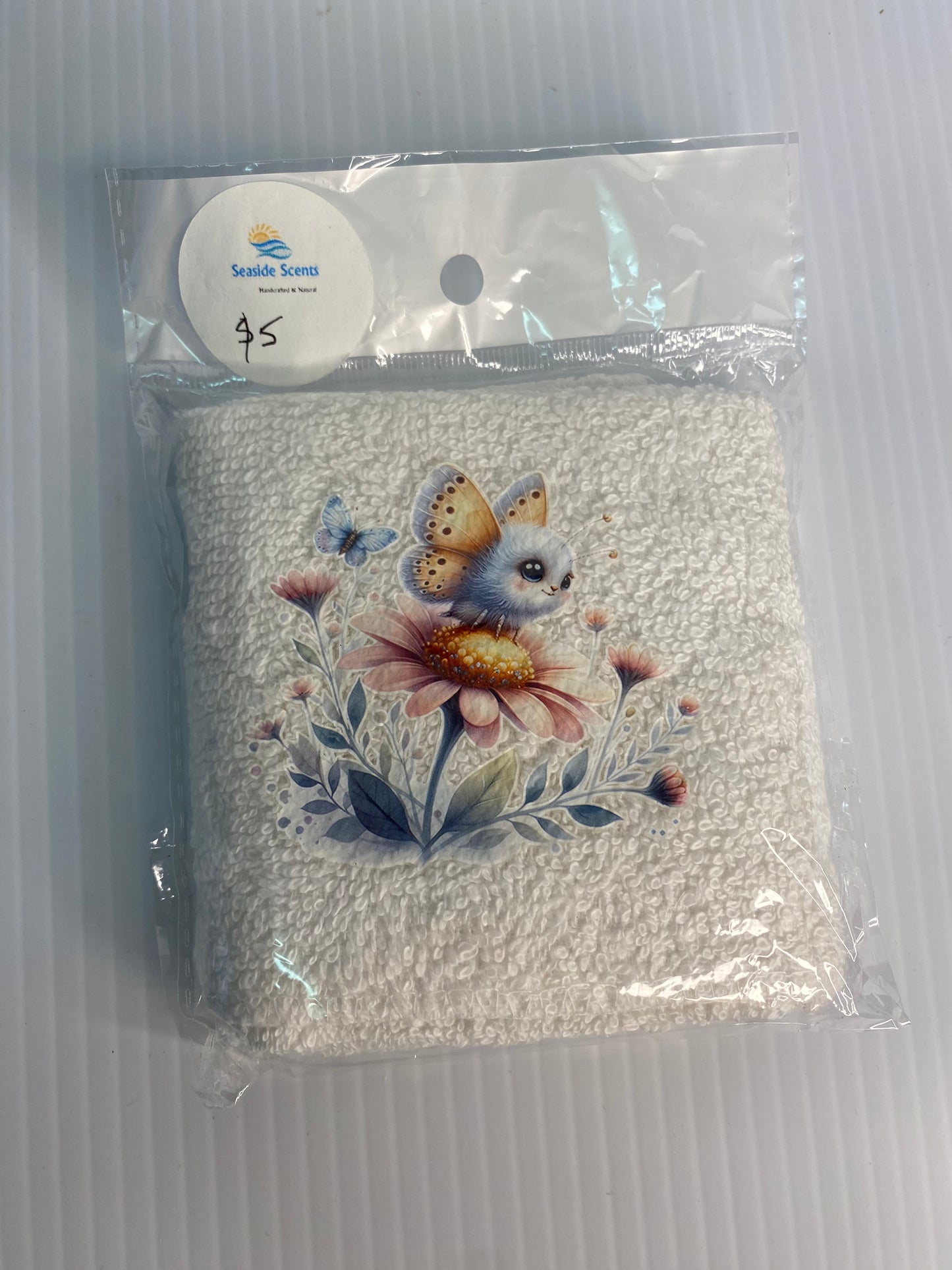 Baby Face Washer- Small Fury Winged Fluff Ball and Butterfly  on a White Washer
